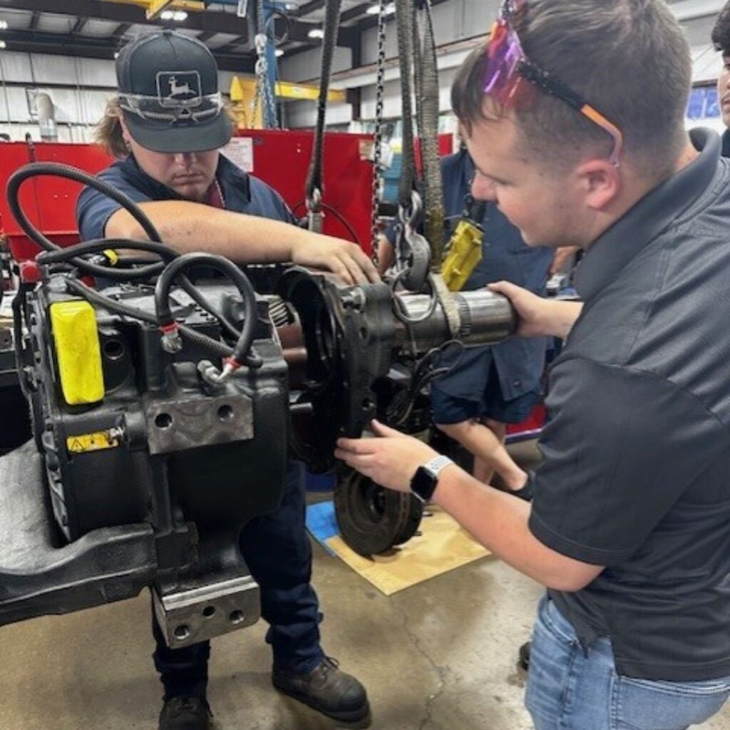 Two men working on machinery together